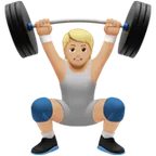 person lifting weights: medium-light skin tone สำหรับแพลตฟอร์ม Apple