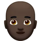 man: dark skin tone, bald alustalla Apple
