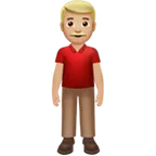 man standing: medium-light skin tone voor Apple platform