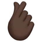 hand with index finger and thumb crossed: dark skin tone สำหรับแพลตฟอร์ม Apple