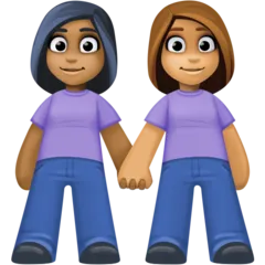 women holding hands: medium-dark skin tone, medium skin tone for Facebook platform