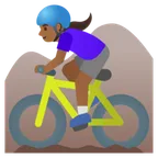 woman mountain biking: medium-dark skin tone لمنصة Google