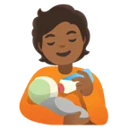 person feeding baby: medium-dark skin tone สำหรับแพลตฟอร์ม Google