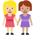women holding hands: medium-light skin tone, medium skin tone for X / Twitter platform